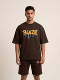 Man wearing a brown 'Blaze' t-shirt and shorts on a beige background