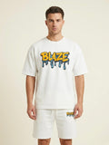 Man wearing a white t-shirt with 'BLAZE' logo and matching shorts on a beige background