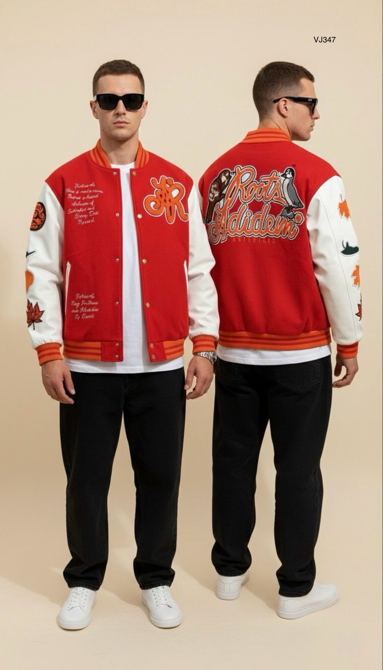 Man wearing a red varsity jacket with white lettering and black pants on a beige background
